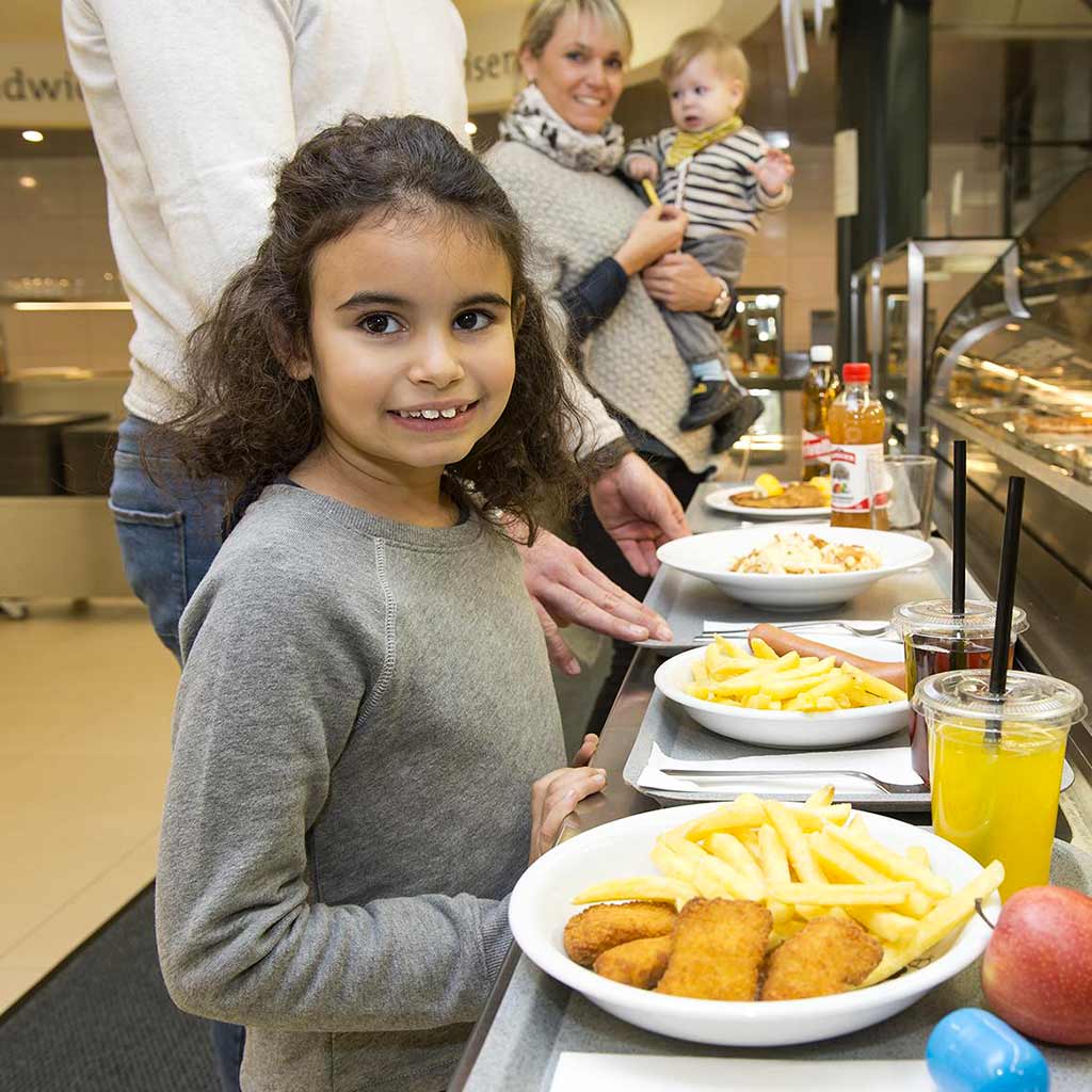Girl with children’s menu at the serving counter